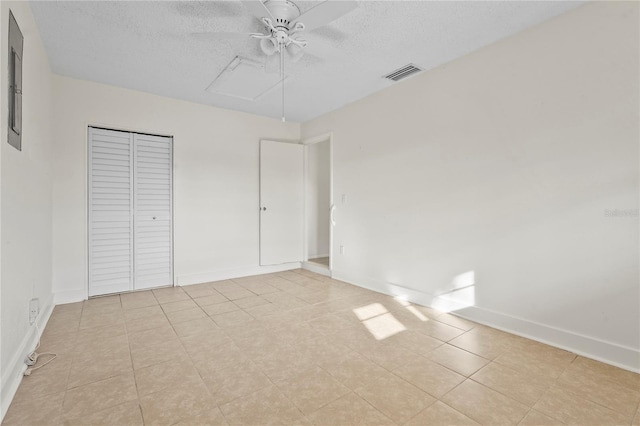 unfurnished bedroom featuring a closet, visible vents, ceiling fan, a textured ceiling, and baseboards