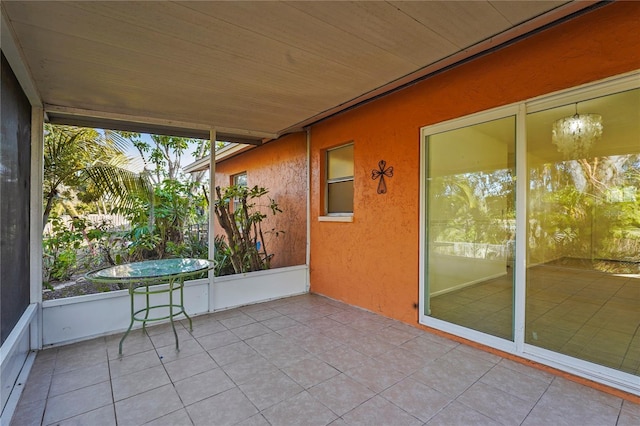 unfurnished sunroom with wood ceiling and a notable chandelier