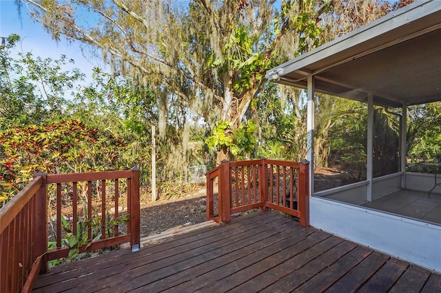 wooden deck featuring a sunroom