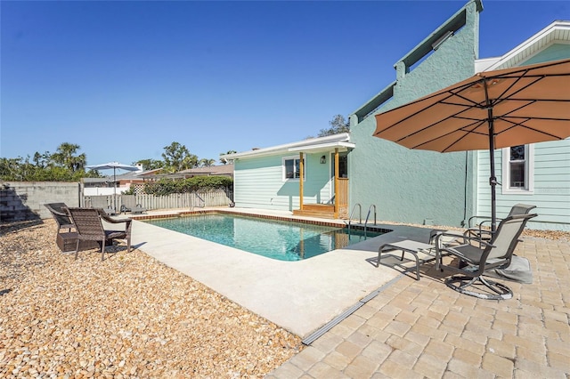 view of pool featuring a patio area, fence, and a fenced in pool