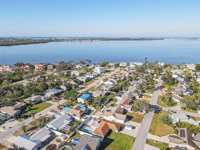 drone / aerial view featuring a residential view and a water view