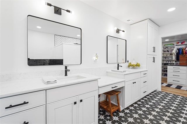 full bathroom featuring a spacious closet, vanity, recessed lighting, and tile patterned floors