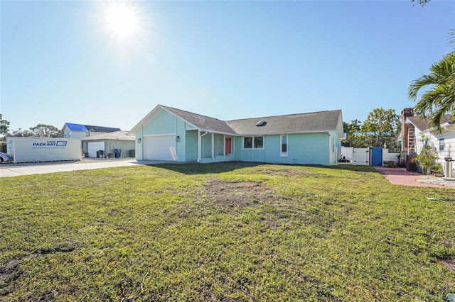 single story home with concrete driveway, a gate, fence, a garage, and a front lawn