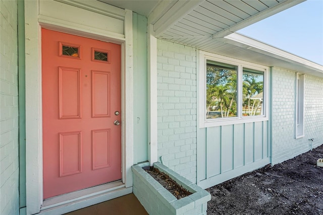 doorway to property with brick siding