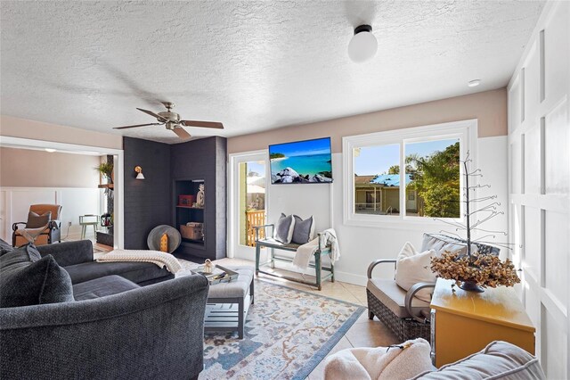 tiled living room featuring a ceiling fan and a textured ceiling