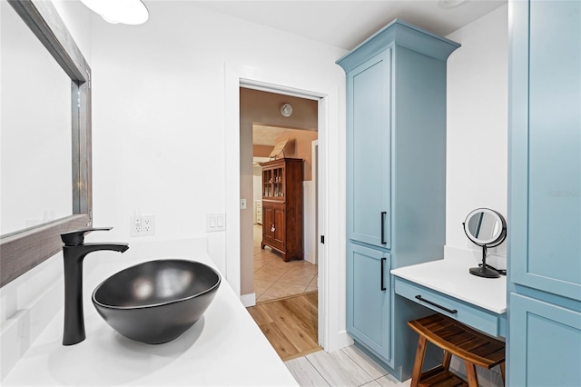 bathroom with a sink and wood finished floors