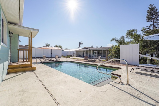 view of pool featuring a patio area, fence, and a fenced in pool