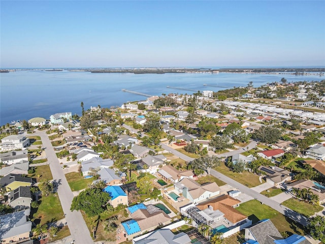 drone / aerial view featuring a water view and a residential view