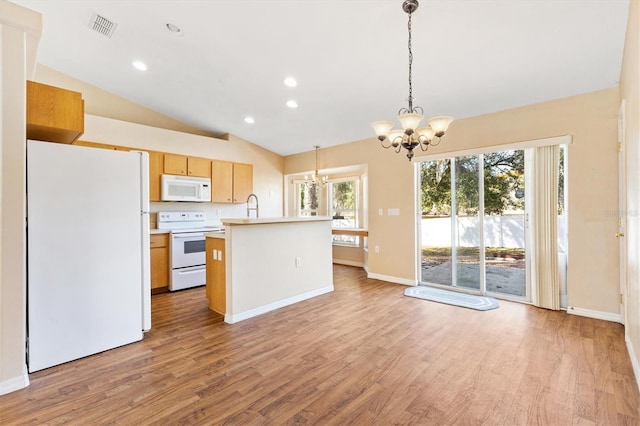 kitchen featuring white appliances, lofted ceiling, decorative light fixtures, light countertops, and a chandelier