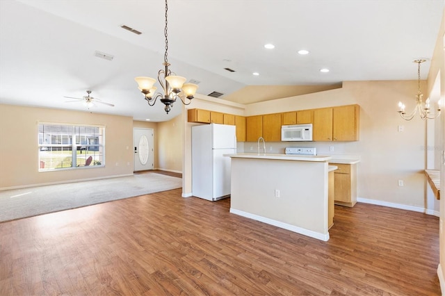 kitchen featuring a kitchen island with sink, white appliances, open floor plan, light countertops, and vaulted ceiling