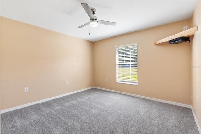 unfurnished room featuring carpet flooring, ceiling fan, and baseboards