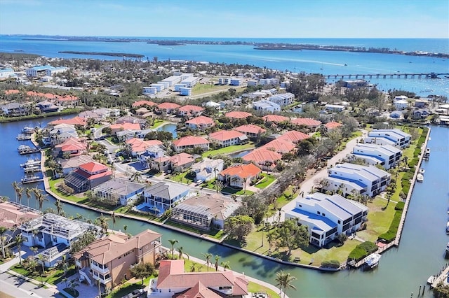 drone / aerial view with a water view and a residential view