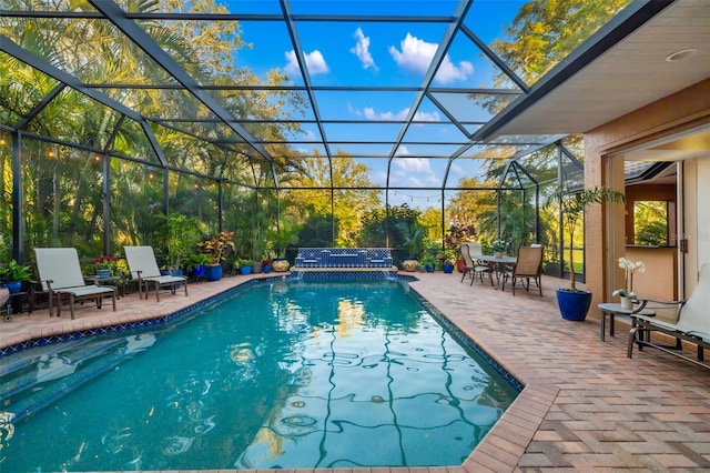 pool with a patio area and a lanai