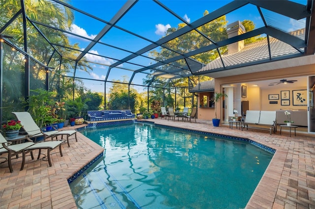 pool featuring an outdoor living space, a lanai, and a patio area