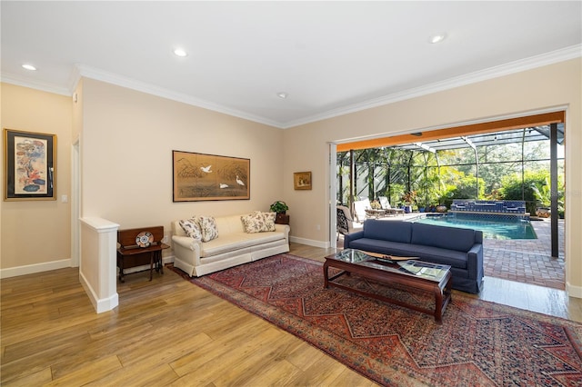 living area featuring ornamental molding, a sunroom, recessed lighting, light wood finished floors, and baseboards