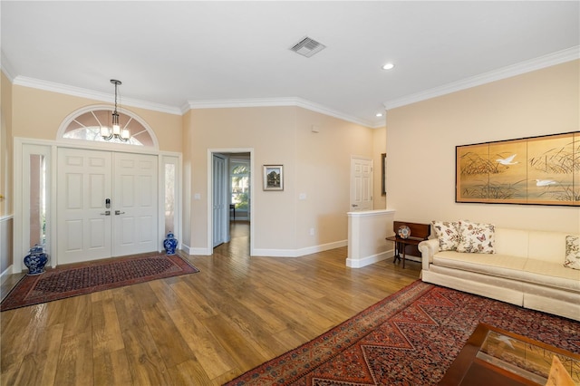 foyer featuring visible vents, a healthy amount of sunlight, and wood finished floors