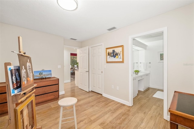 interior space featuring visible vents, baseboards, and light wood-style floors