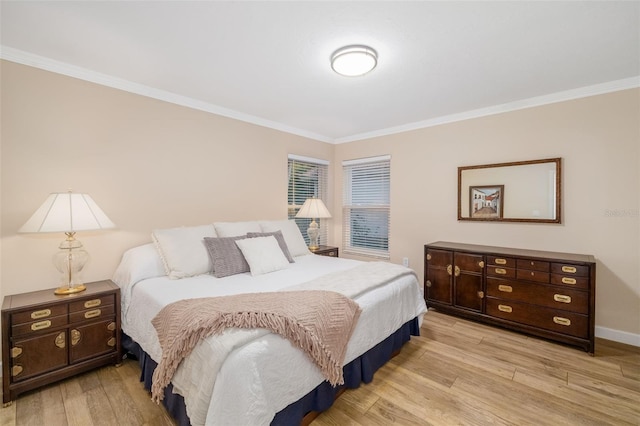 bedroom featuring crown molding, light wood-type flooring, and baseboards