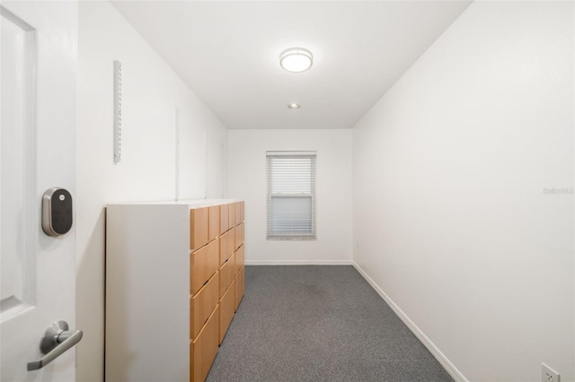 spacious closet featuring dark colored carpet