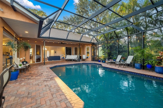 outdoor pool with a patio, a lanai, and an outdoor hangout area