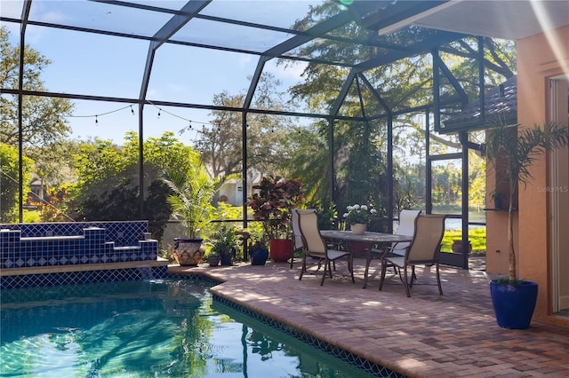 outdoor pool with a patio and a lanai