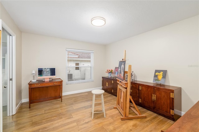 office space featuring baseboards and light wood-style floors