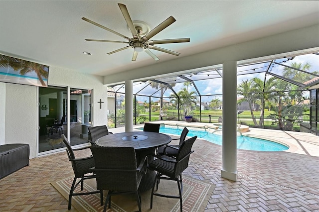 exterior space featuring a lanai, a pool with connected hot tub, and ceiling fan