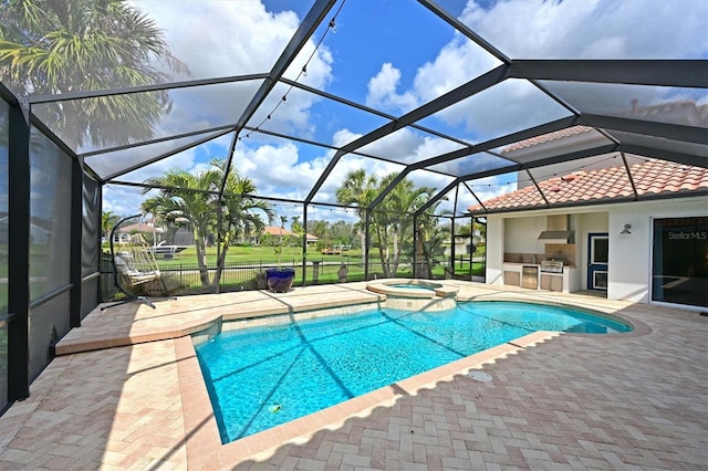 view of swimming pool featuring a patio, area for grilling, an outdoor bar, a lanai, and a pool with connected hot tub