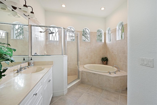 bathroom featuring a stall shower, tile patterned floors, vanity, a bath, and recessed lighting