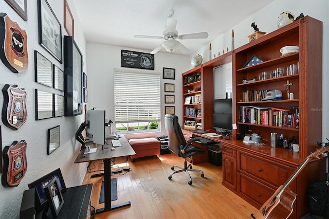 office space featuring light wood-type flooring and a ceiling fan