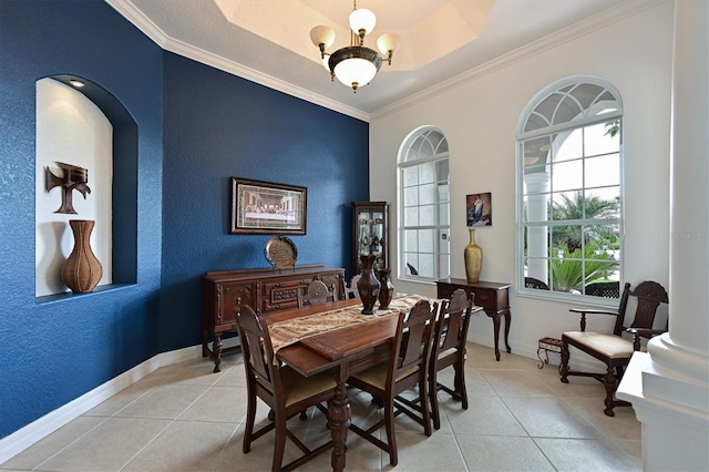 dining room with light tile patterned floors, a textured wall, a chandelier, baseboards, and crown molding