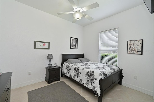 bedroom with light tile patterned floors, ceiling fan, and baseboards