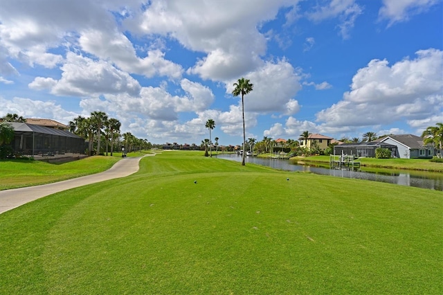 view of community with a water view, a residential view, golf course view, and a yard