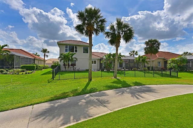 view of community featuring a residential view, fence, and a lawn