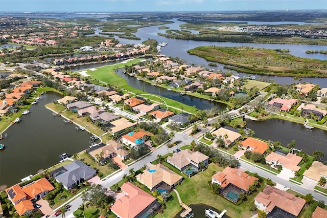 birds eye view of property with a water view and a residential view