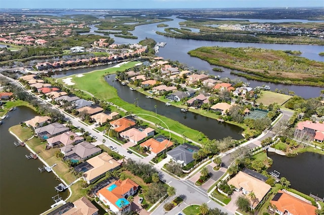 birds eye view of property with a water view and a residential view