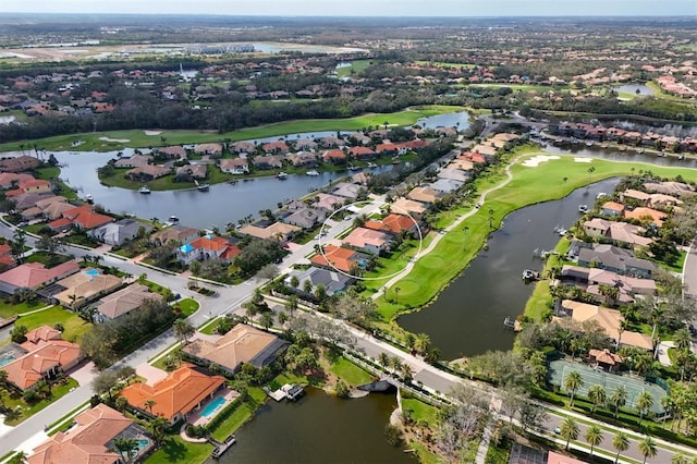 aerial view featuring a residential view, view of golf course, and a water view