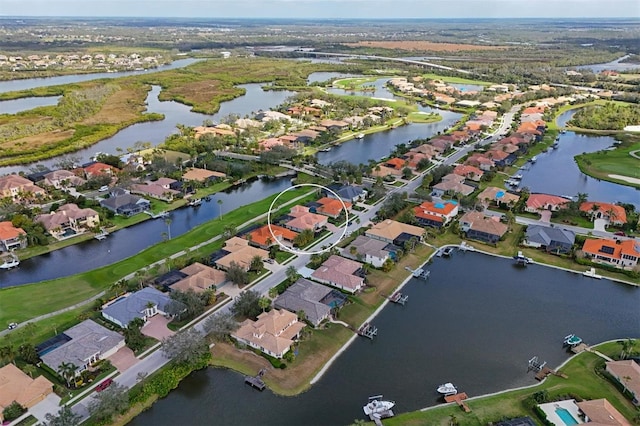 drone / aerial view with a water view and a residential view