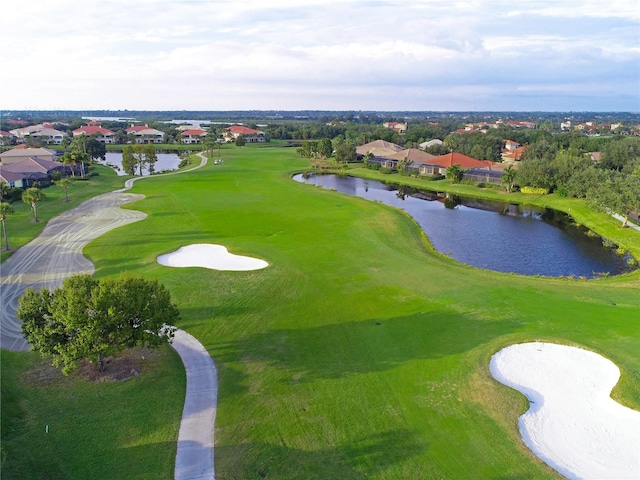 drone / aerial view with a residential view, a water view, and golf course view