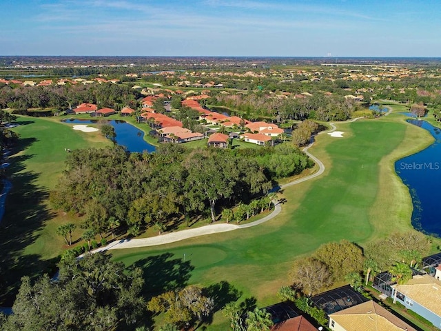 aerial view with golf course view and a water view