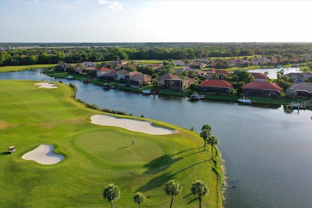 bird's eye view featuring golf course view, a water view, and a residential view