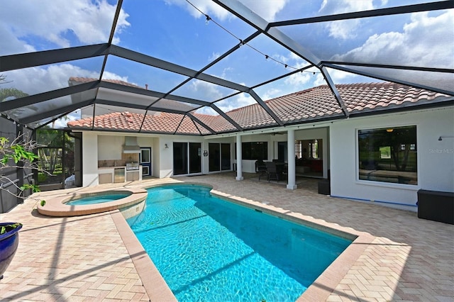 10509 Winding Stream Way, Bradenton, FL 34212 - view of swimming pool with area for grilling, a patio, a pool with connected hot tub, and glass enclosure