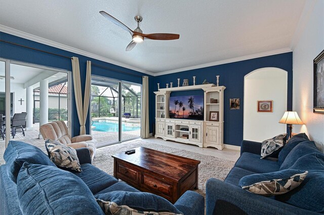 10509 Winding Stream Way, Bradenton, FL 34212 - living room with a ceiling fan, arched walkways, ornamental molding, and a sunroom