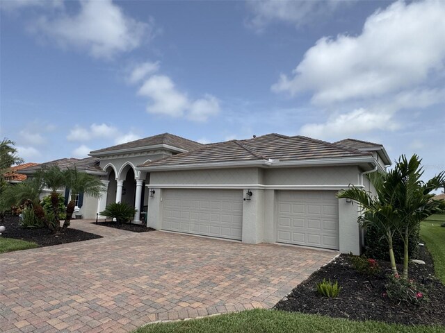 10509 Winding Stream Way, Bradenton, FL 34212 - view of front facade featuring an attached garage, stucco siding, driveway, and a tile roof