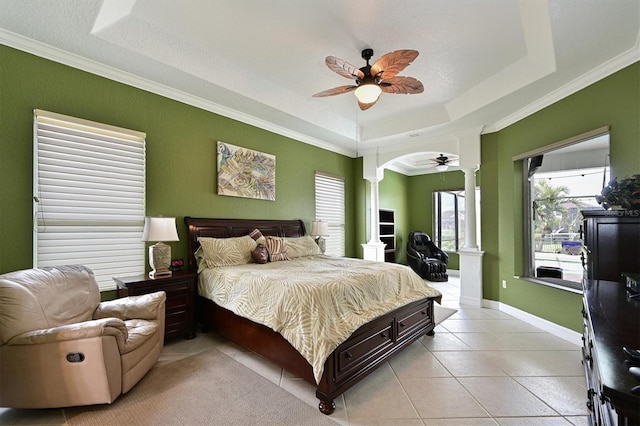 10509 Winding Stream Way, Bradenton, FL 34212 - bedroom featuring decorative columns, a raised ceiling, light tile patterned flooring, arched walkways, and crown molding