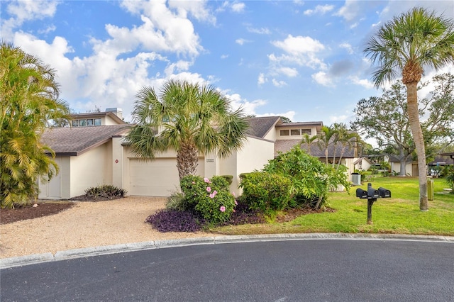 view of front of property with a front yard and a garage