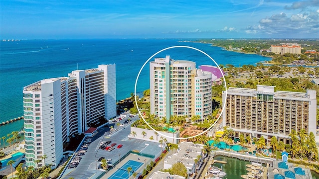 birds eye view of property with a water view and a view of city