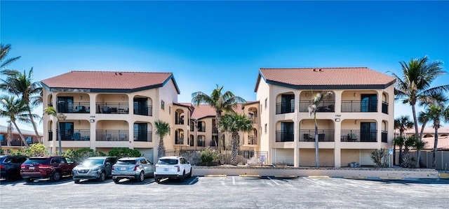 view of building exterior with uncovered parking