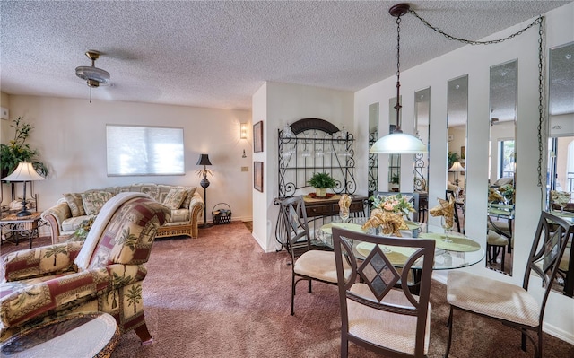 carpeted dining room with a textured ceiling