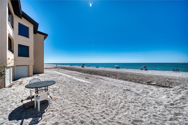 property view of water featuring a beach view